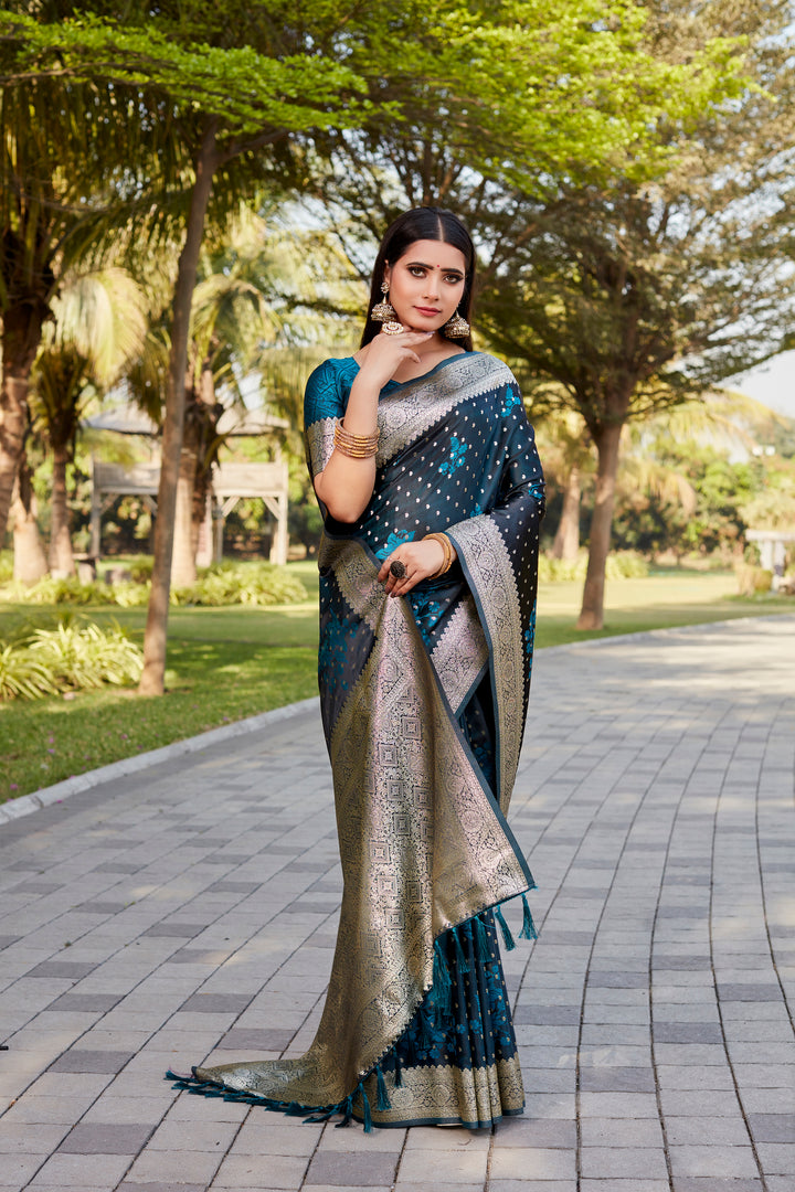 Stunning teal-blue Soft Satin Kanjivaram saree with intricate butta work and luxurious shine.