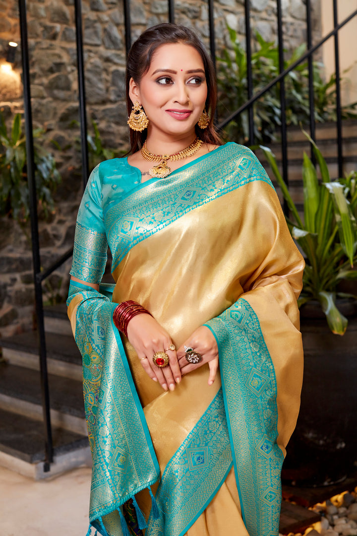 Golden Tissue silk saree with traditional weaving and bold contrast border design.