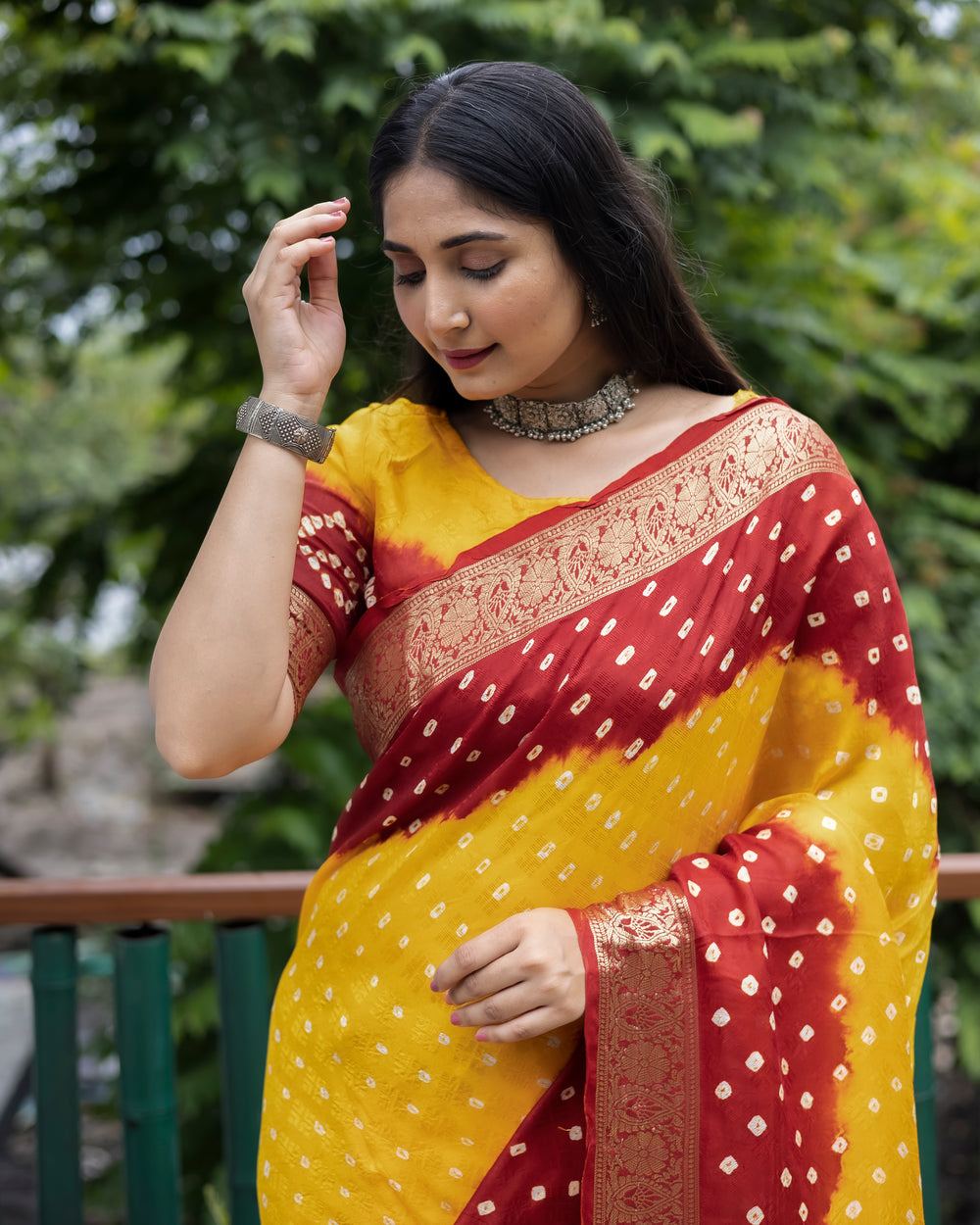 Beautiful yellow Bandhej silk saree with intricate zari detailing and matching blouse, ideal for traditional celebrations.