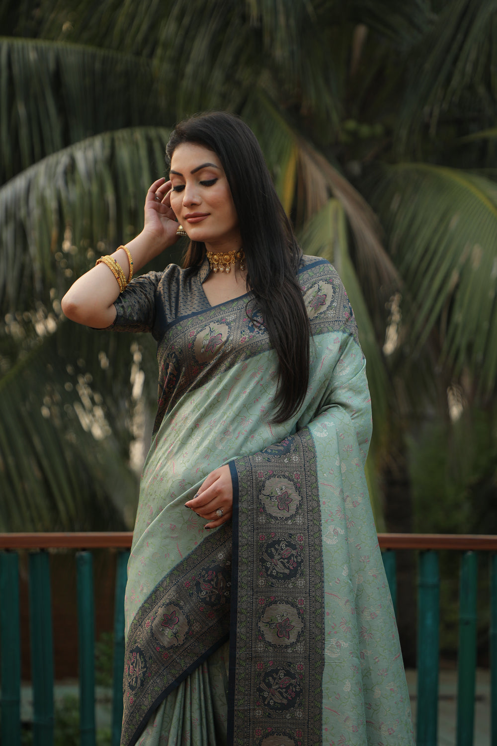 Timeless green Kanjivaram saree featuring beautiful border designs and a shimmering finish, ideal for special occasions.