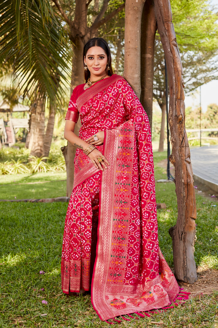 Hot pink Gharchola Bandhej silk saree featuring intricate zari weaving and meenakari borders, perfect for festive occasions and weddings.