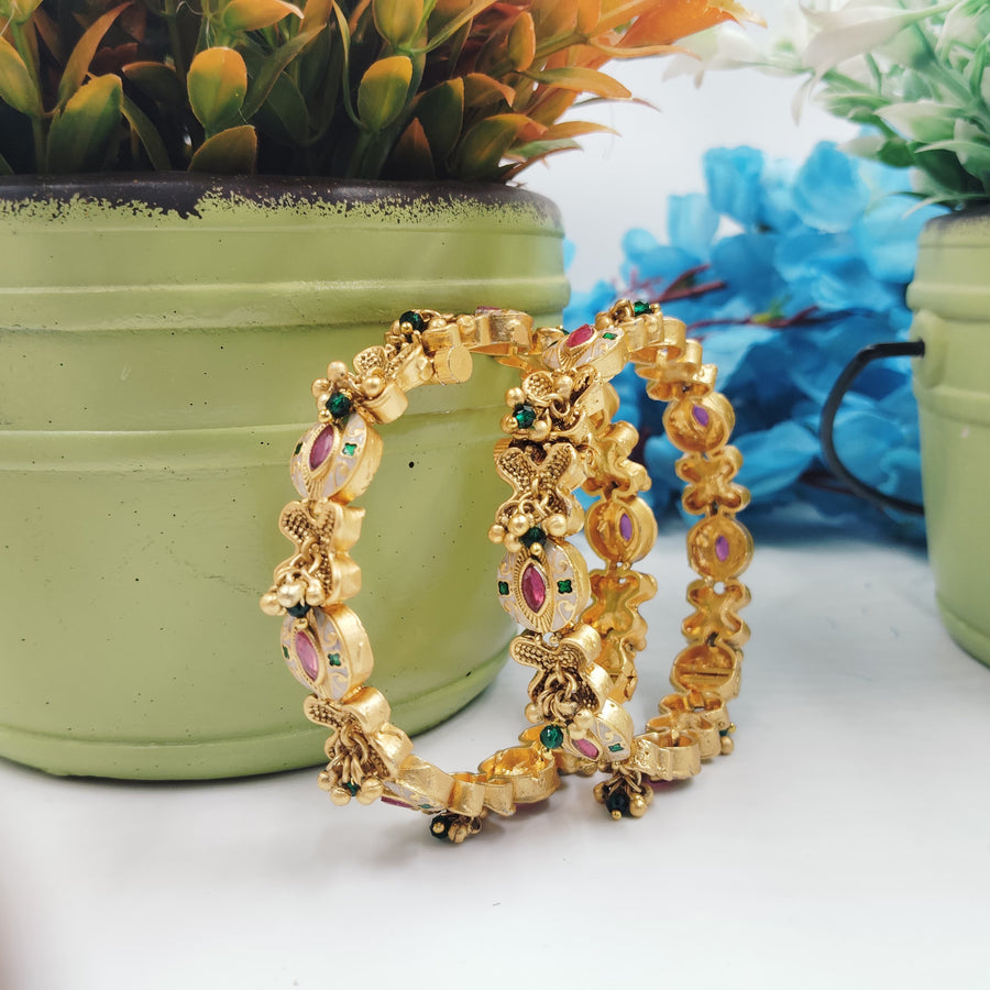 Golden bangles featuring beaded details for an ethnic look.