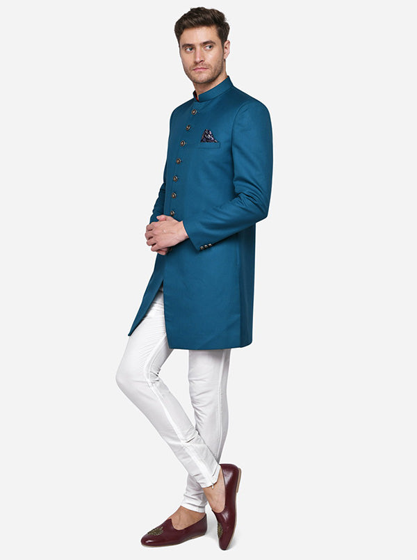 The turquoise color adds a fresh twist to traditional Indian menswear, making it a fashionable option for festive indo-western outfits in the USA.