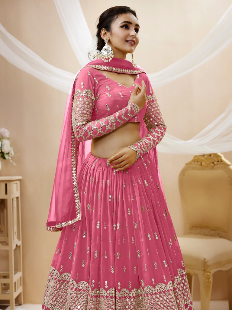 Elegant pink georgette lehenga with sequins and zari embroidery, ideal for festive occasions and bridal wear.