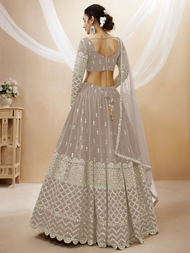 Beautiful grey lehenga choli in georgette with exquisite sequins and zari detailing, ideal for festive events.