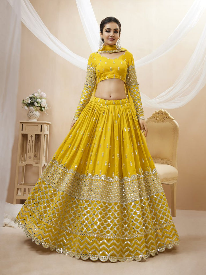 Traditional yellow georgette lehenga set featuring sequins and zari work, ideal for wedding celebrations.