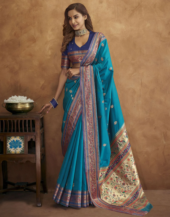 Sea-blue Pethani silk saree with gold zari motifs and Meenakari border, perfect for festive occasions.