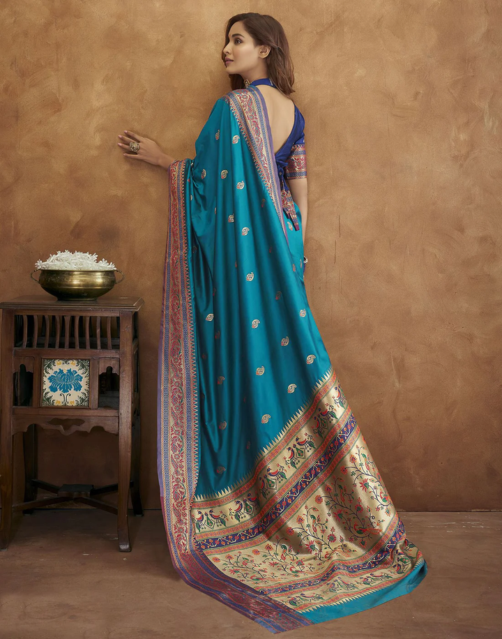 Elegant sea-blue Pethani silk saree featuring gold zari motifs and Meenakari border for weddings.