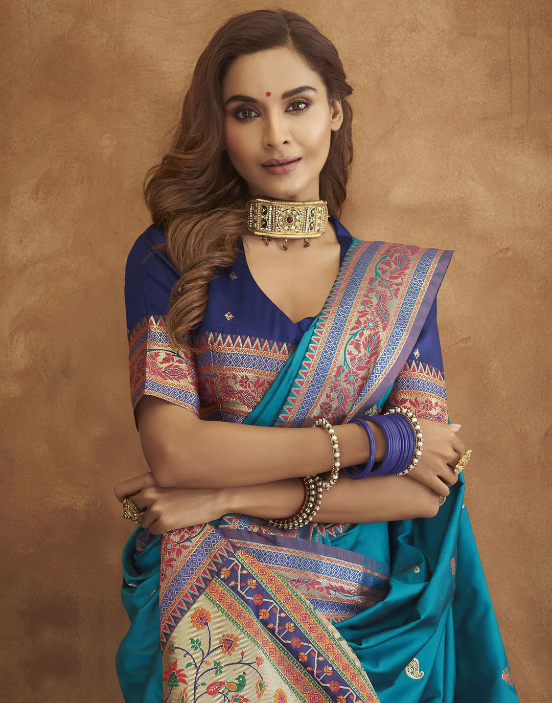 Stunning sea-blue Pethani silk saree with gold zari motifs and Meenakari border for cultural celebrations.