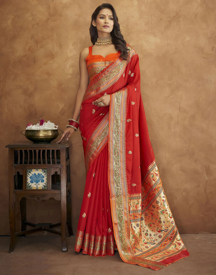 Elegant red Pethani silk saree with gold zari detailing and Meenakari border for cultural events.