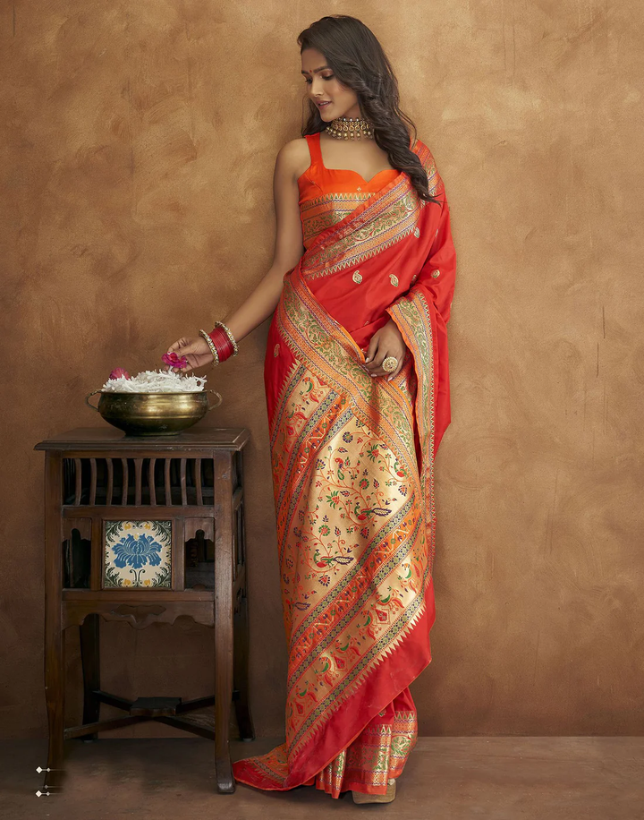 Timeless red Pethani silk saree with gold zari motifs and Meenakari border for special occasions.