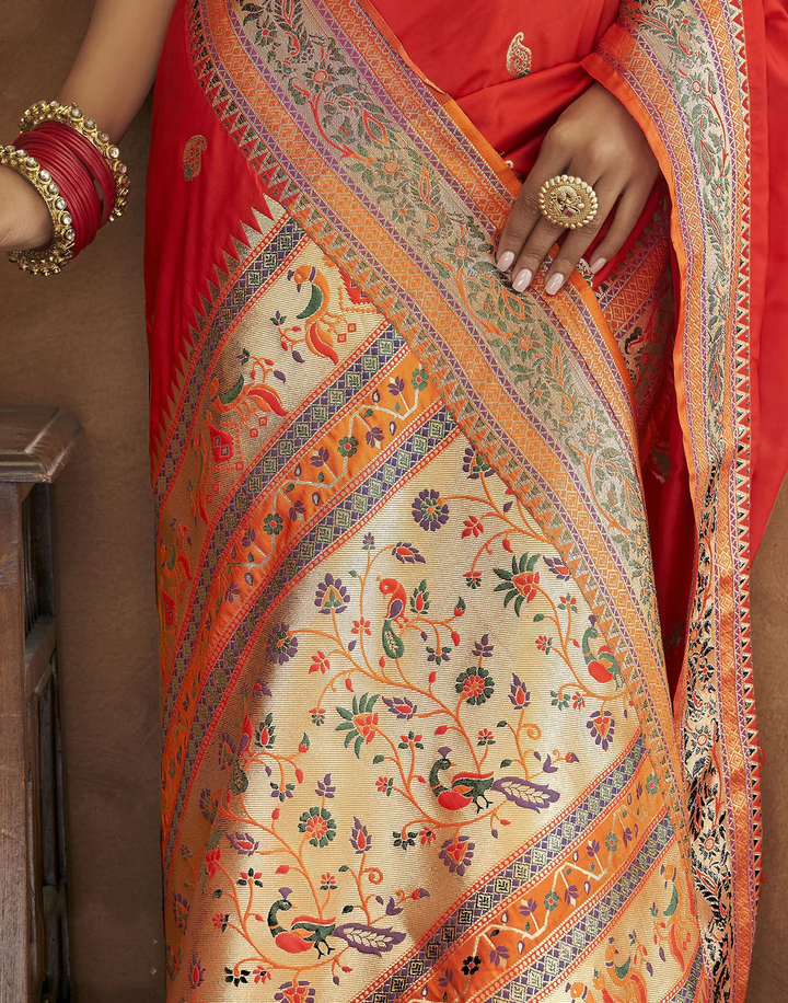 Stunning red Pethani silk saree featuring gold zari motifs and Meenakari border for festive gatherings.