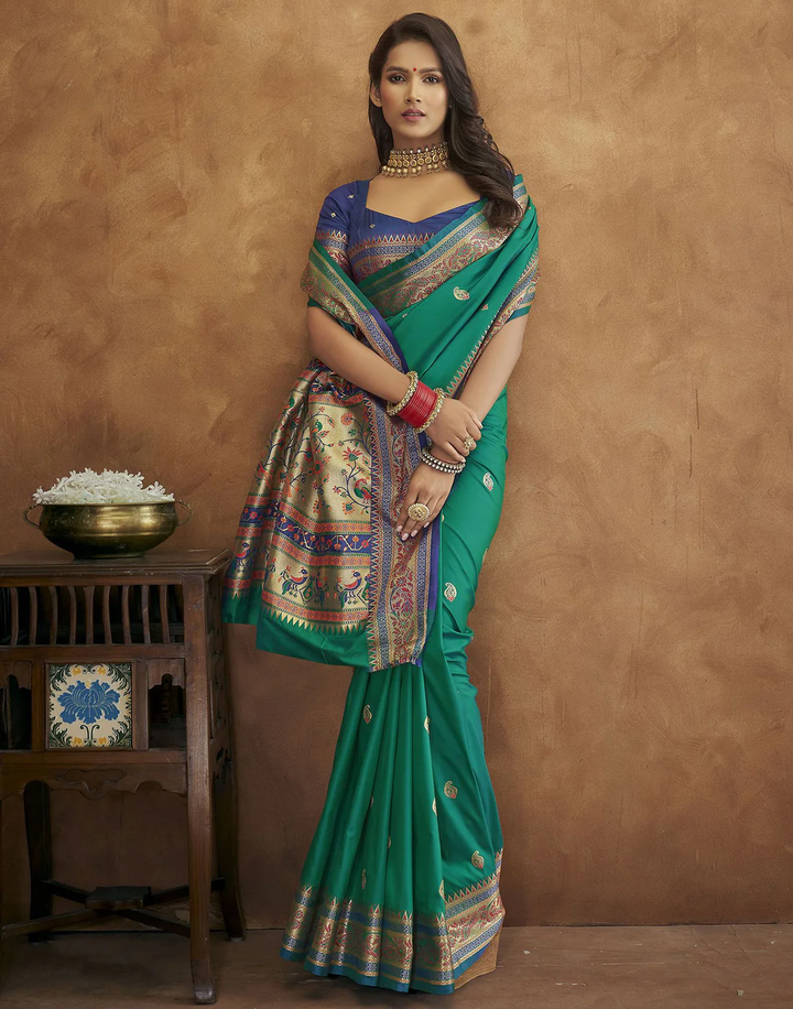 Timeless green Pethani silk saree with gold zari motifs and Meenakari border, perfect for festive events.