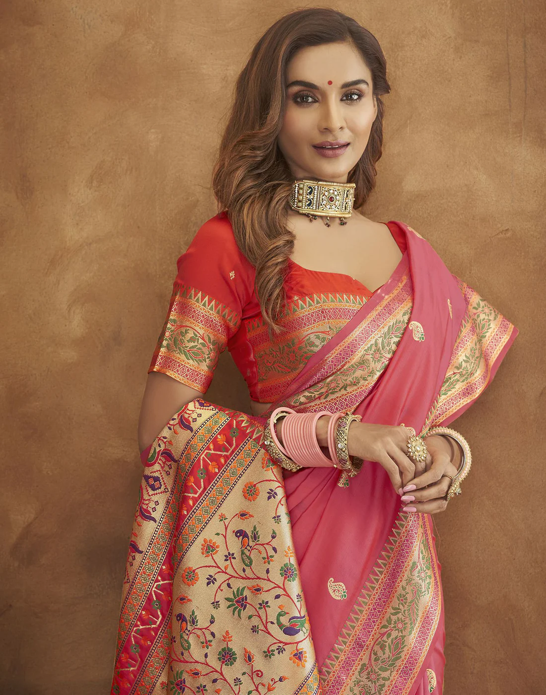 Traditional pink Pethani silk saree with gold zari motifs and Meenakari border, perfect for weddings.