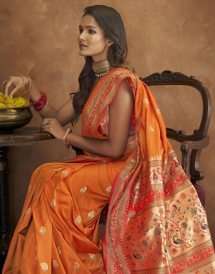 Designer orange Pethani silk saree with gold zari work and Meenakari border for grand occasions.