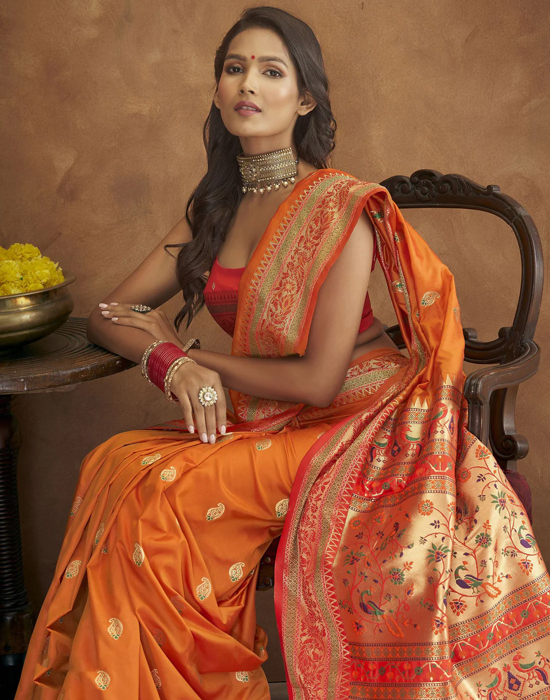 Burgundy Pethani silk saree with gold zari motifs and Meenakari border, perfect for weddings.