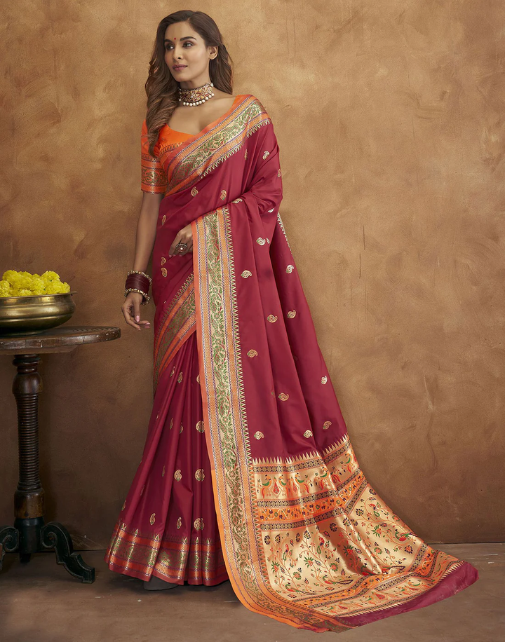 Stunning burgundy Pethani silk saree with gold zari motifs and Meenakari border, ideal for cultural gatherings.