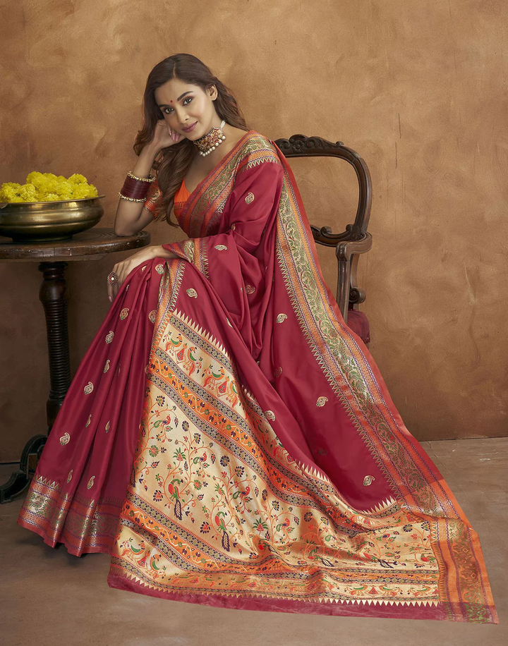 Timeless burgundy Pethani silk saree with gold zari detailing and Meenakari border for traditional celebrations.