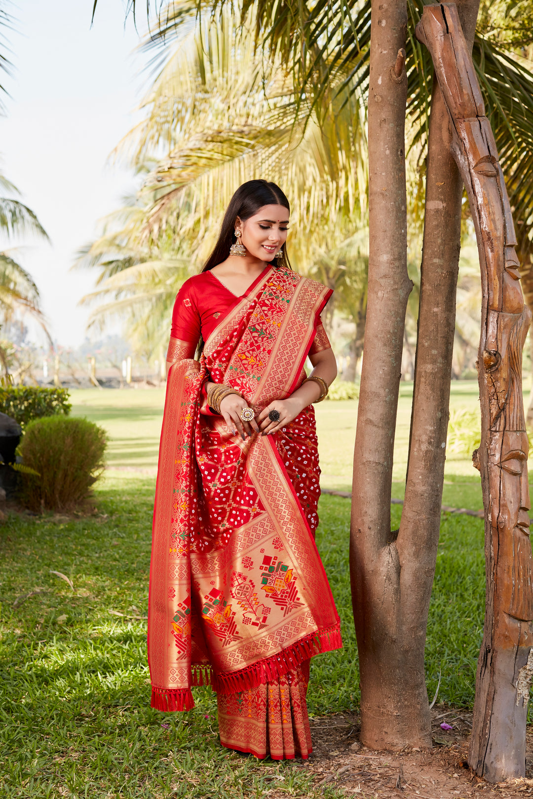 Beautiful blue Gharchola Bandhej silk saree featuring zari and meenakari borders, ideal for weddings and special events.