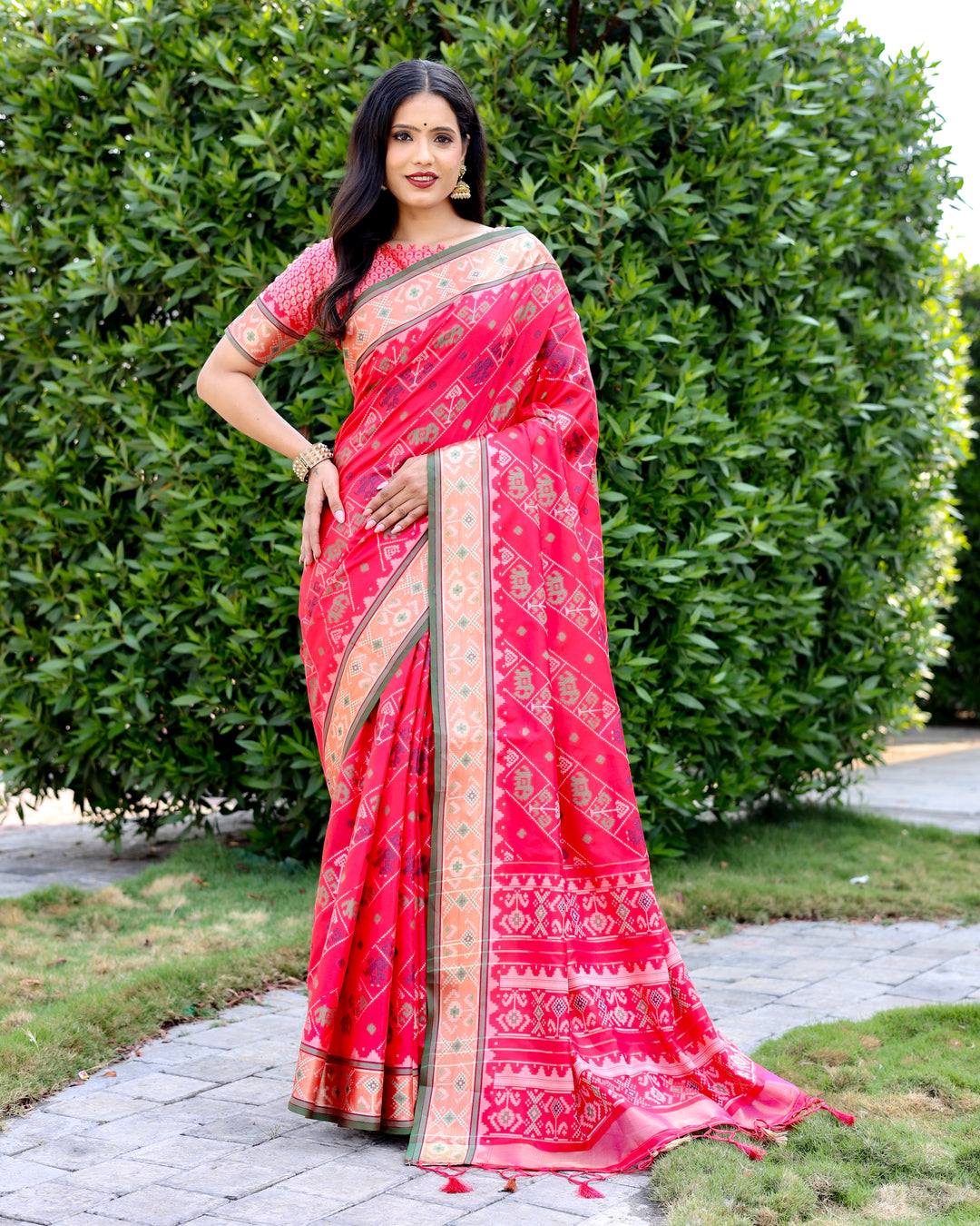 Gorgeous hot-pink Bandhej silk saree with intricate zari woven pallu and matching blouse, perfect for luxury wear.