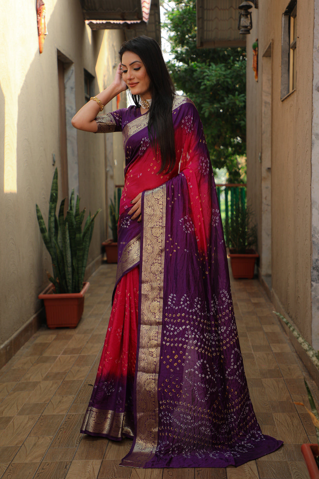 Festive orange Bandhej Tapeta saree with traditional weaving, perfect for celebratory wear.