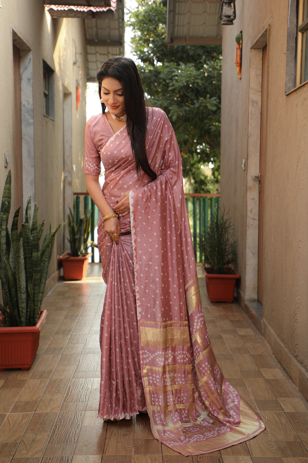 Timeless dusty-rose Bandhej silk saree with elegant checks design for festive wear.