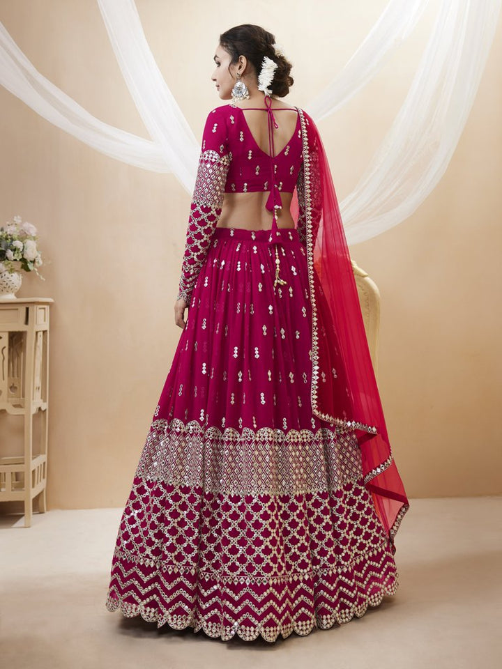 Gorgeous bright-pink lehenga choli in georgette with delicate sequins and zari embroidery, ideal for cultural events.