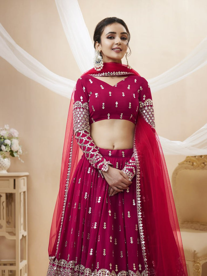 Traditional bright-pink lehenga choli set with exquisite sequins and zari work, designed for bridal occasions.