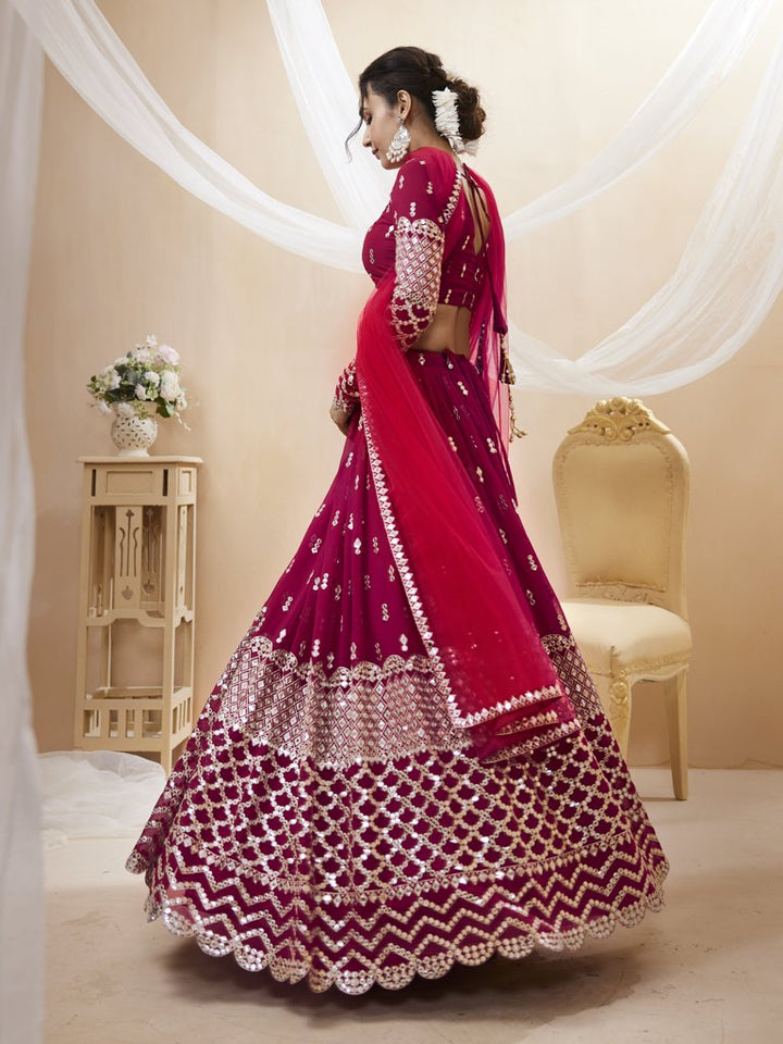 Elegant bright-pink georgette lehenga with sequins and zari work, perfect for luxury wedding celebrations.