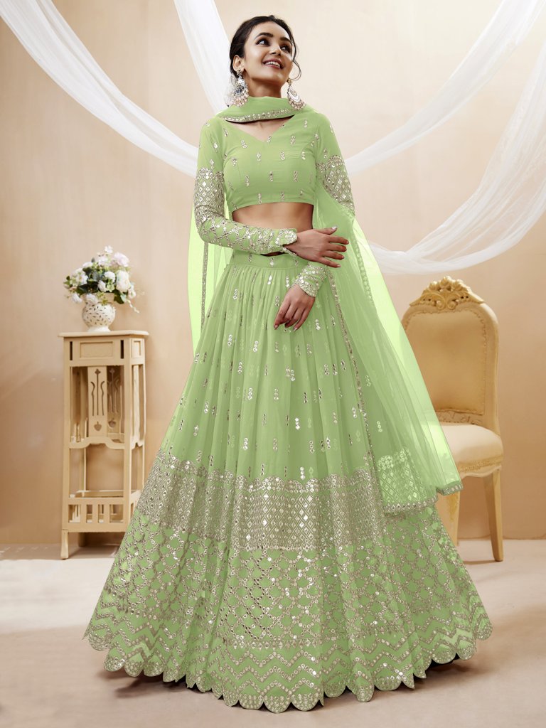 Traditional pista-green lehenga choli with sequins and zari embroidery, designed for elegant wedding wear.