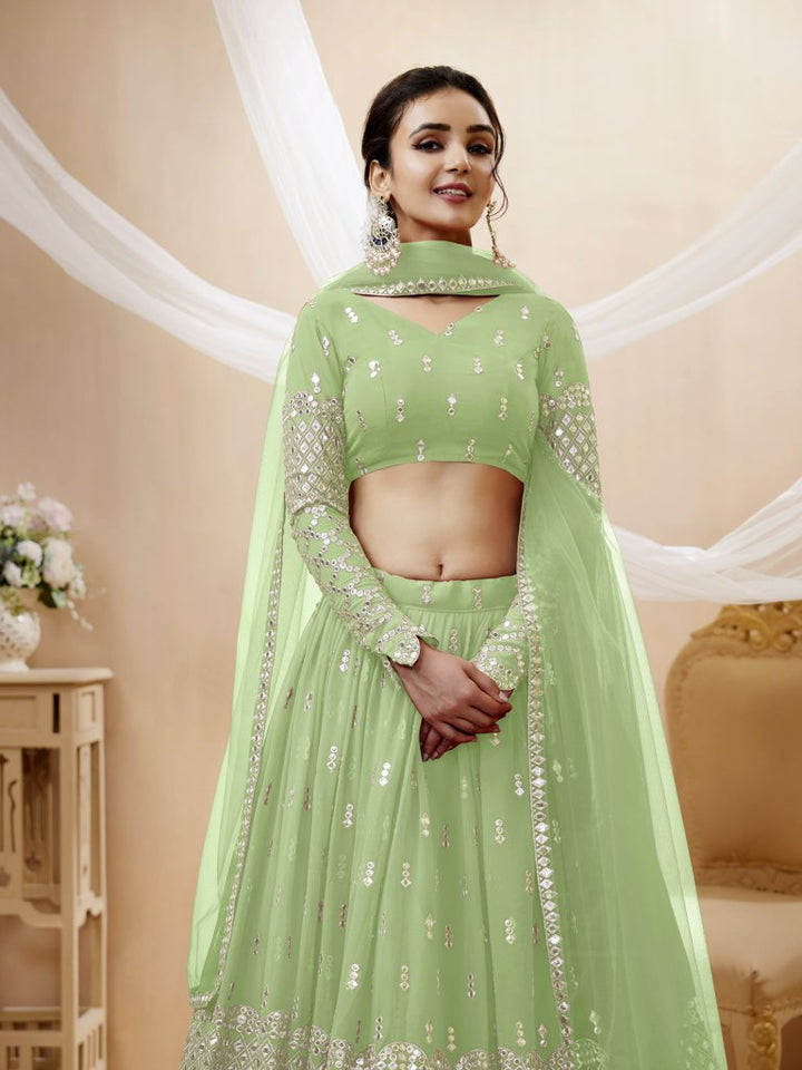 Beautiful pista-green georgette lehenga choli set with delicate sequins and zari work, perfect for bridal occasions.