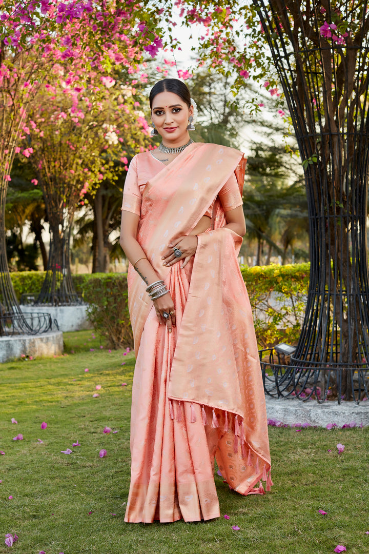 Chic peach Kanjivaram satin silk saree with intricate butta design and woven pallu, perfect for festive occasions.