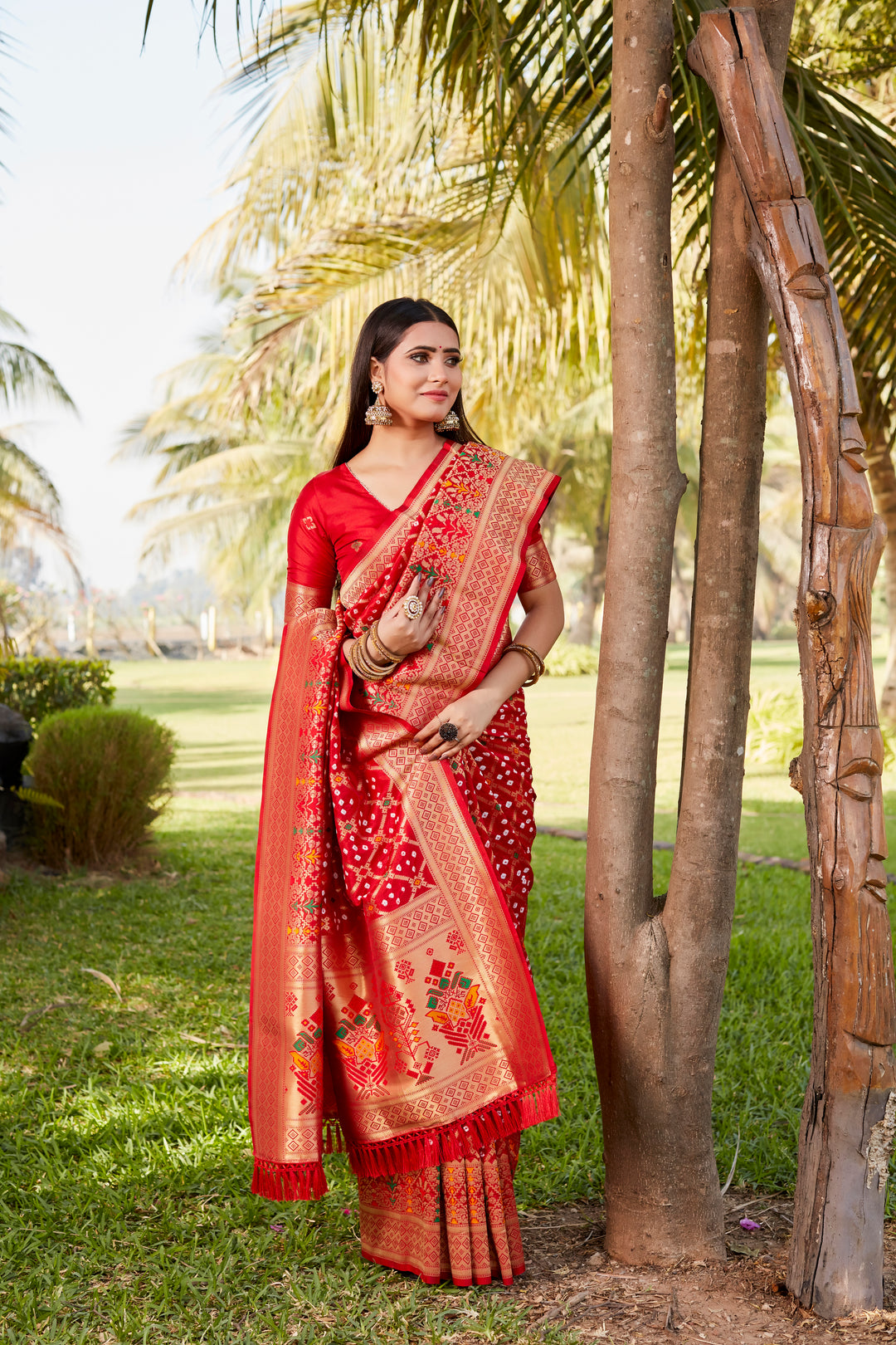 Elegant blue Gharchola Bandhej silk saree with intricate zari weaving and meenakari borders, perfect for cultural celebrations.