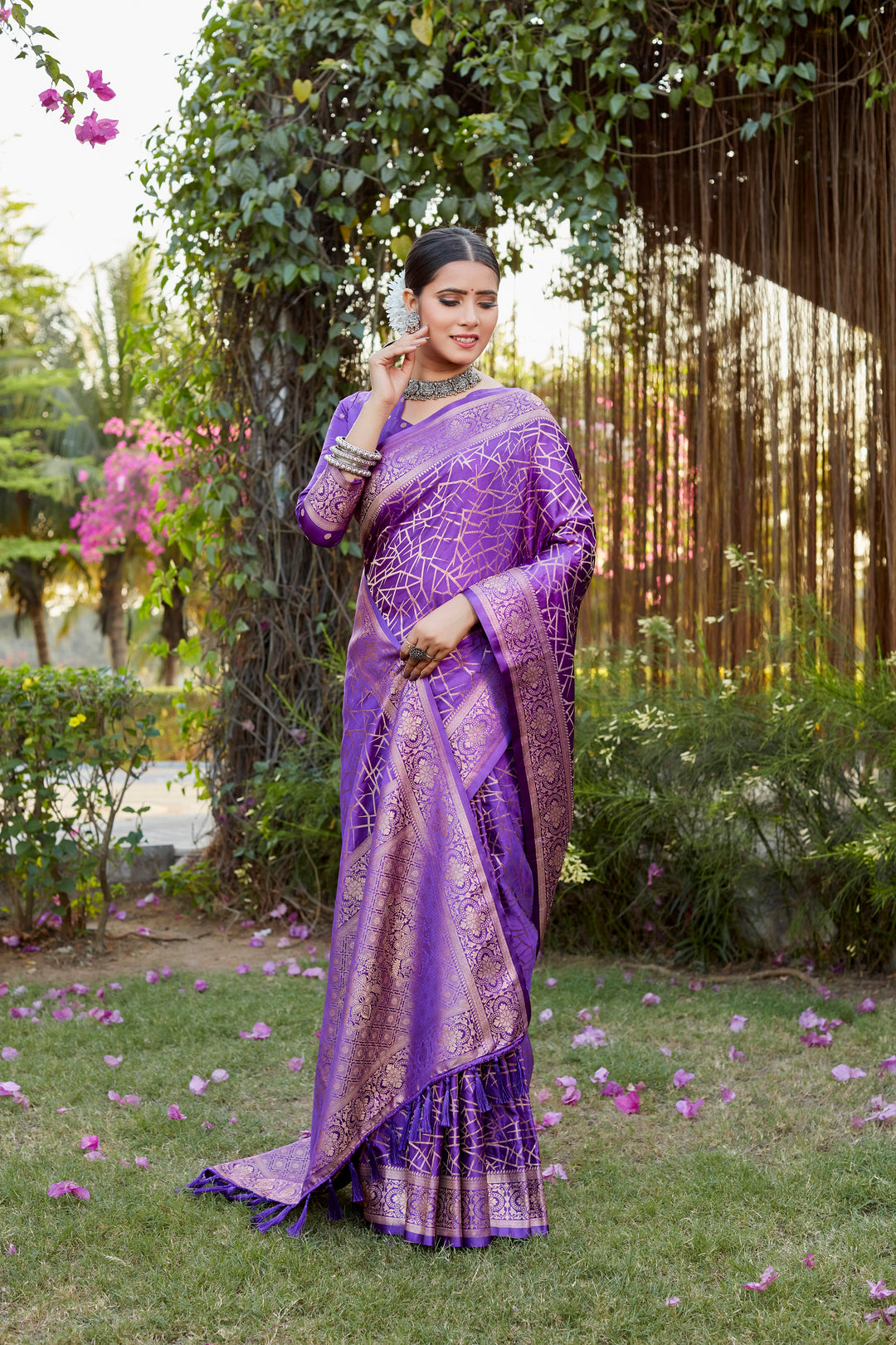 Stylish purple Kanjivaram soft satin silk saree with detailed butta work, perfect for weddings and special events.