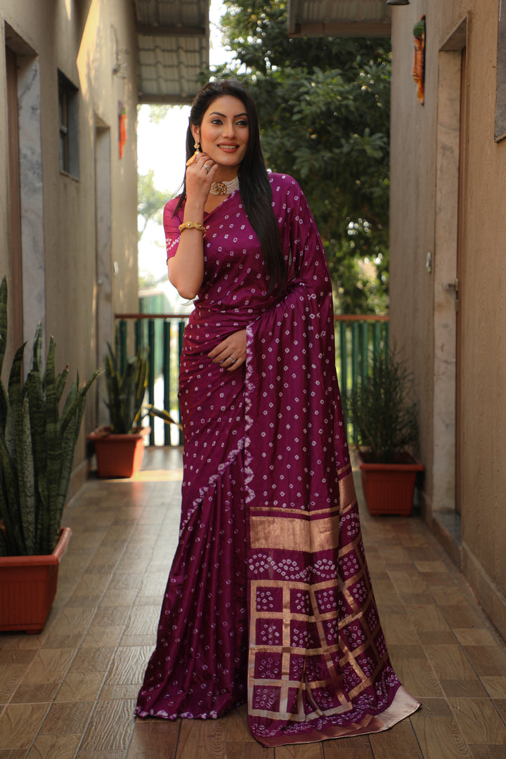 Beautiful wine Bandhej silk saree with original craft and intricate checks design.