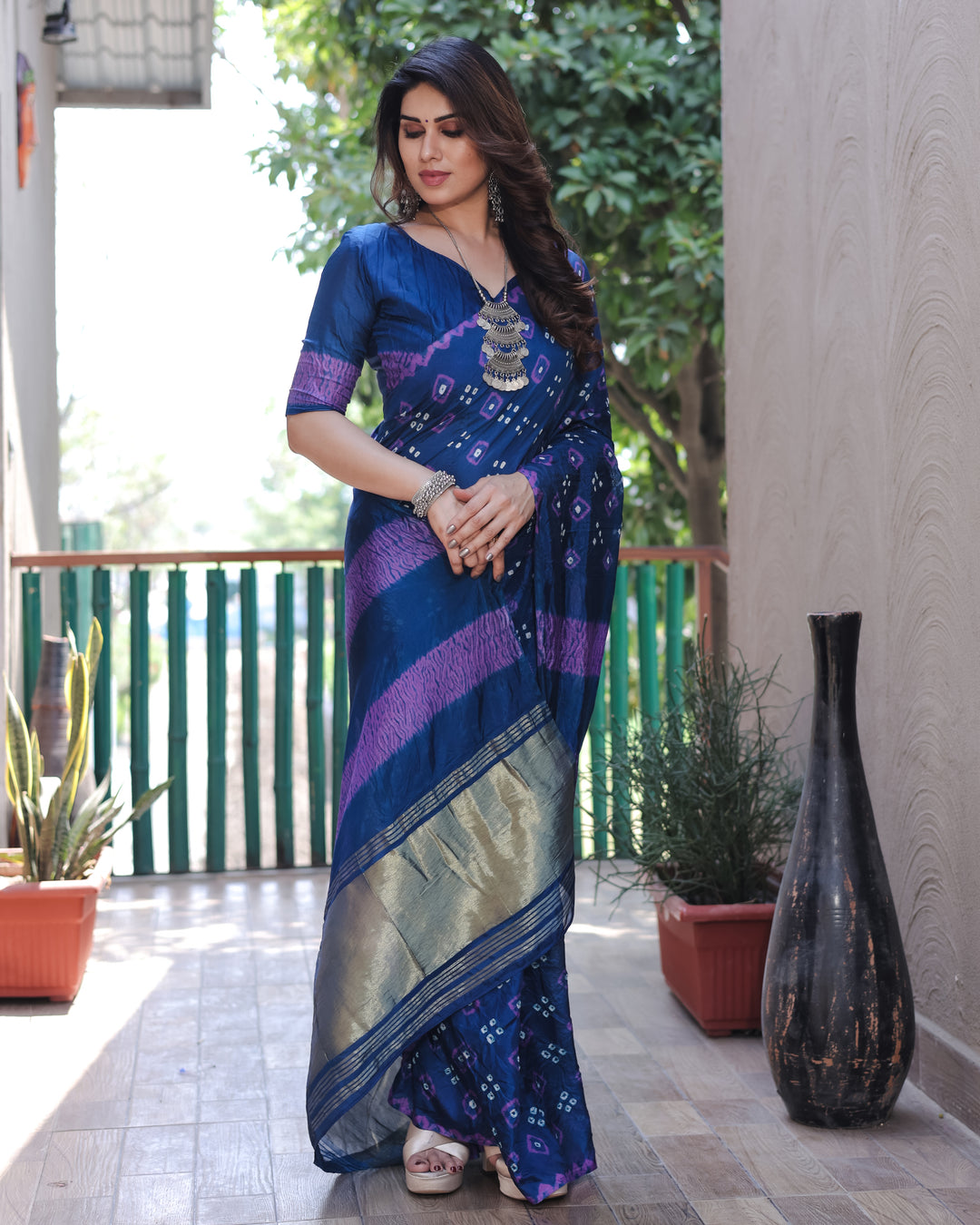 Bold deep blue Bandhej silk saree with intricate traditional motifs and a rich tissue pallu, perfect for any celebration.