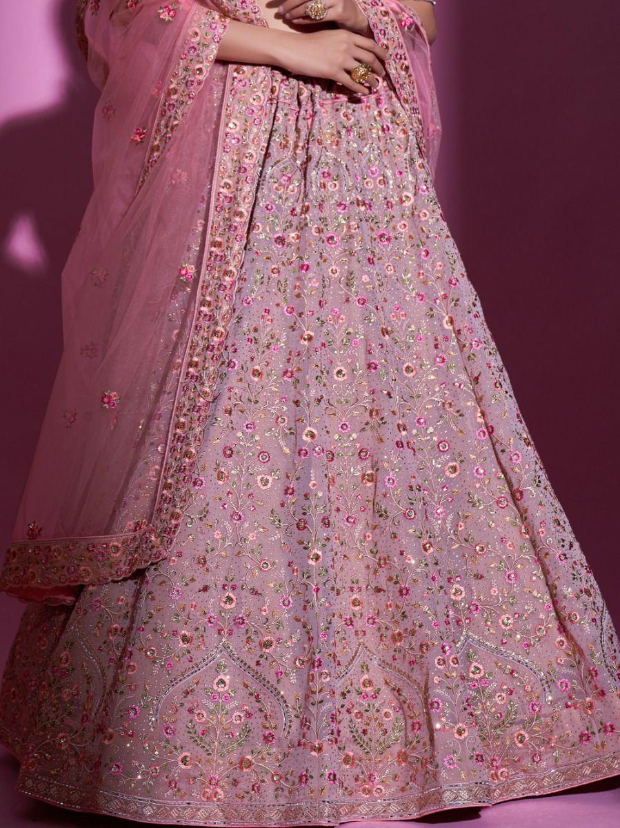 Semi-stitched peach lehenga choli with thread and Swarovski embellishments.