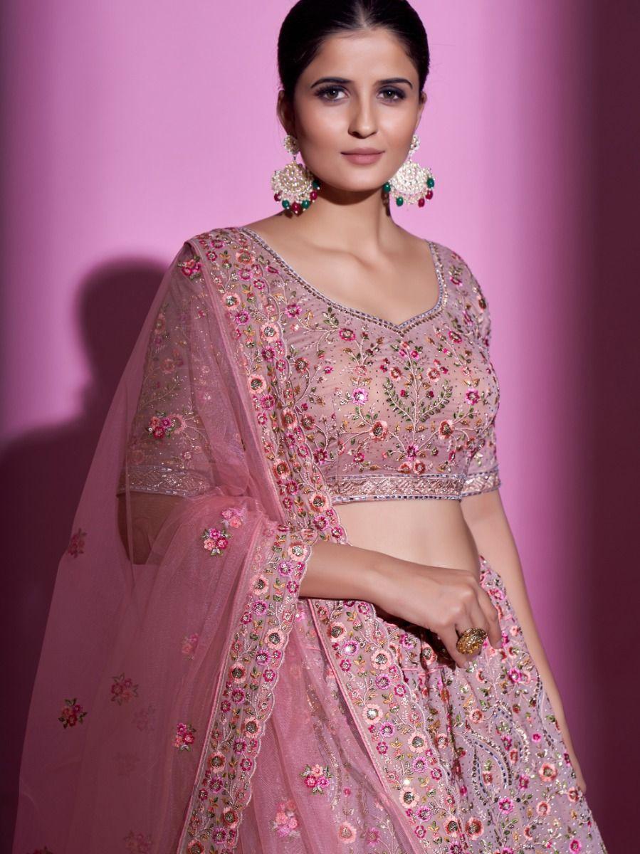 Peach embroidered lehenga choli with matching net dupatta and lace.