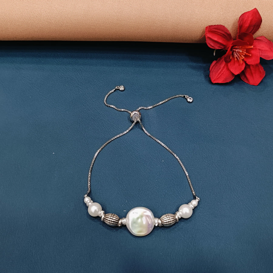 Classic silver bracelet adorned with delicate charms, a timeless accessory.