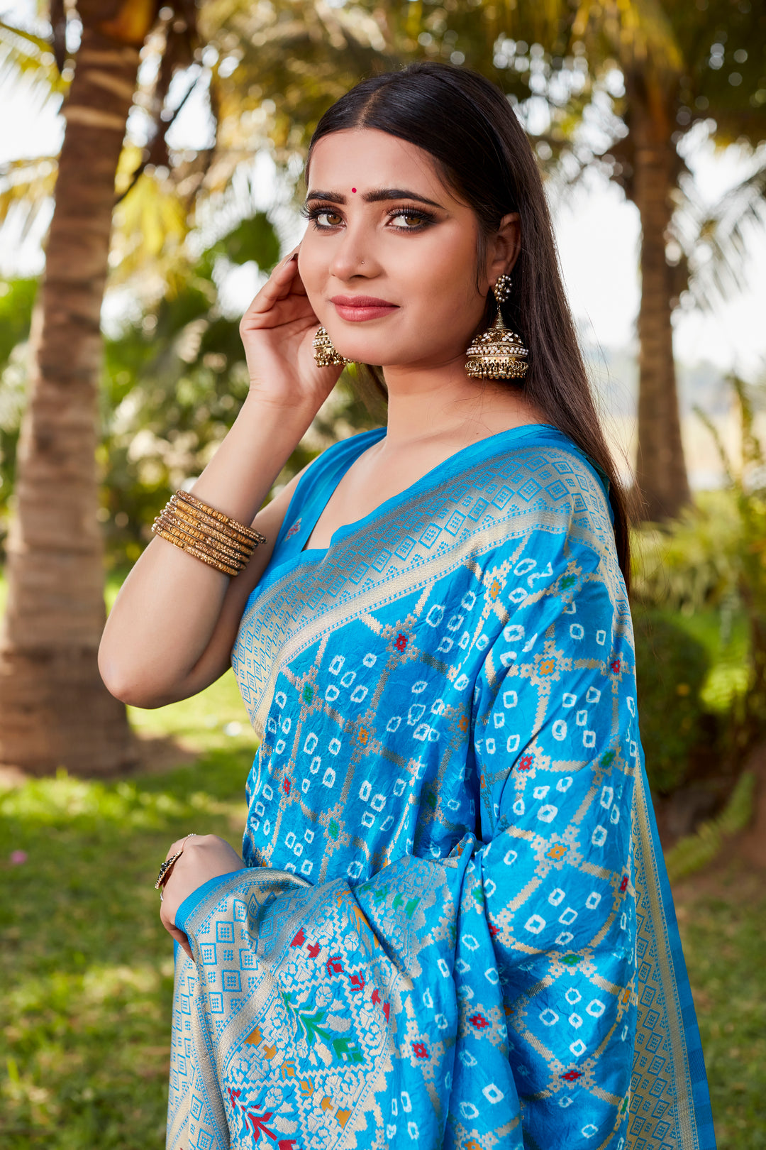 Gorgeous blue Gharchola Bandhej silk saree with zari borders and meenakari weaving, perfect for cultural and traditional events.