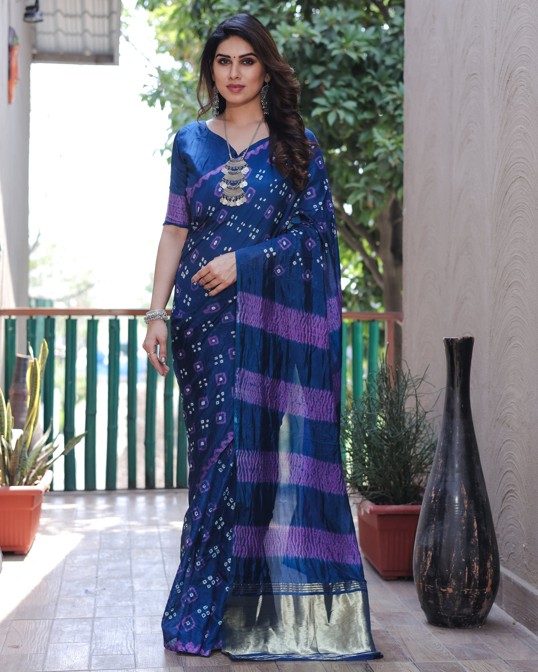 Elegant deep blue Bandhej silk saree with intricate weaving and a rich tissue pallu, designed for festive celebrations.