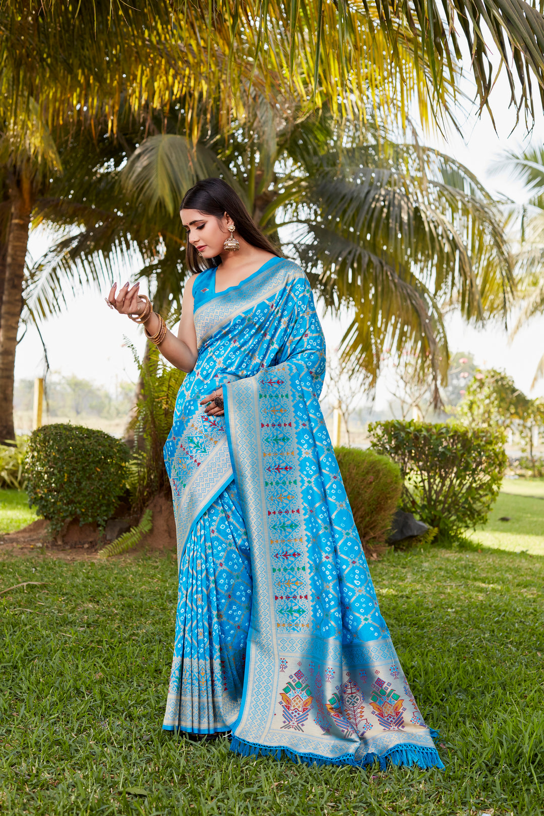 Beautiful red Gharchola Bandhej silk saree with zari and meenakari borders, designed for special occasions and festive celebrations.