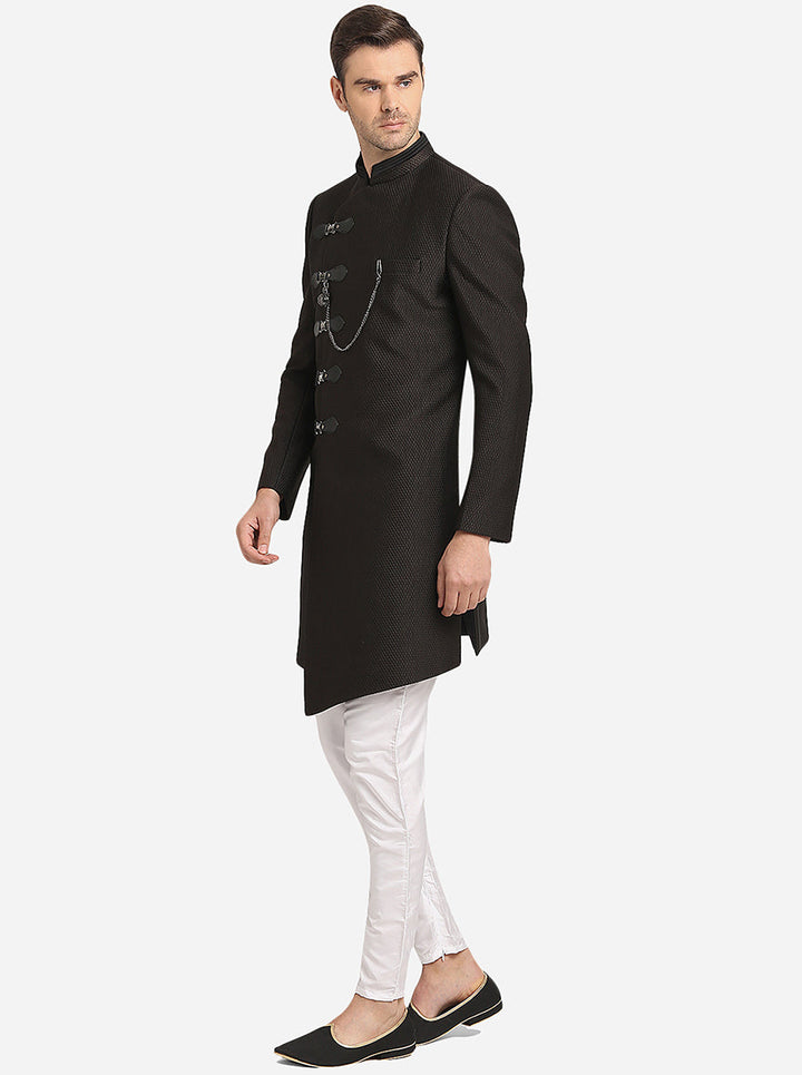 Stylish Black Indo Western for men, featuring asymmetric hem and white churidaar.