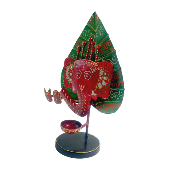 Decorative red and green Ganesha candle holder, a unique addition to your space