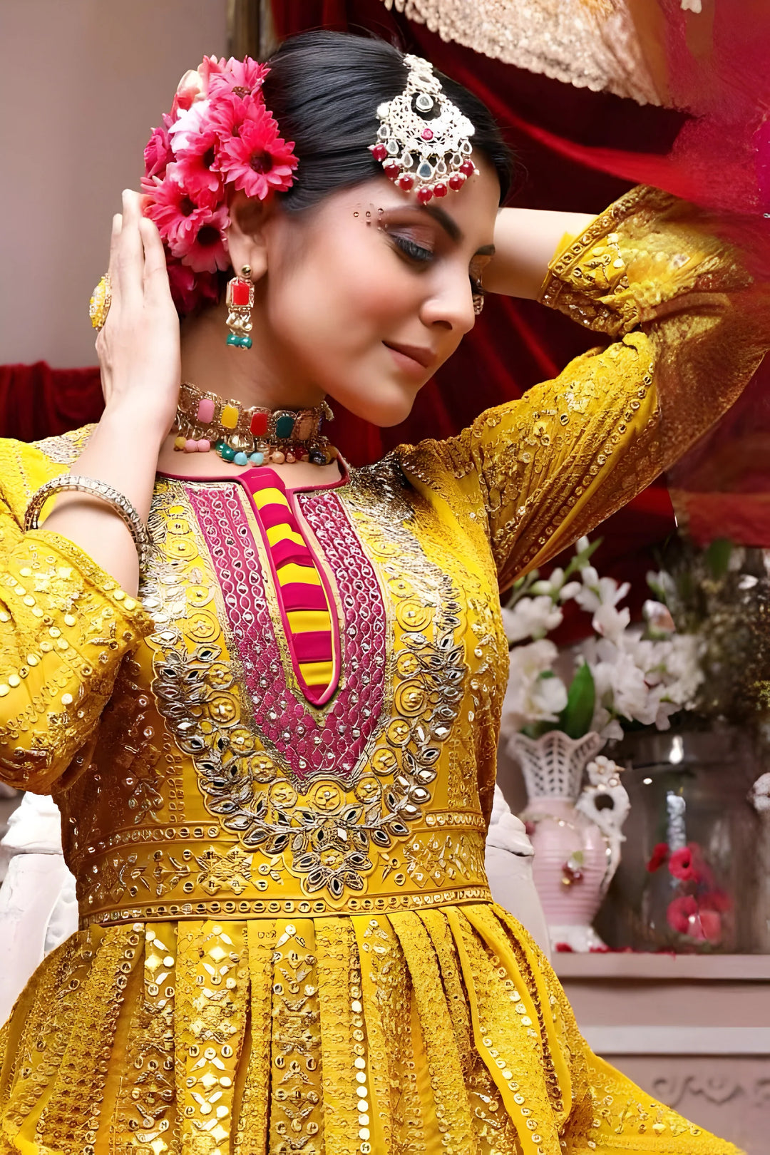 Women’s yellow georgette Garara suit with intricate multicolor design.