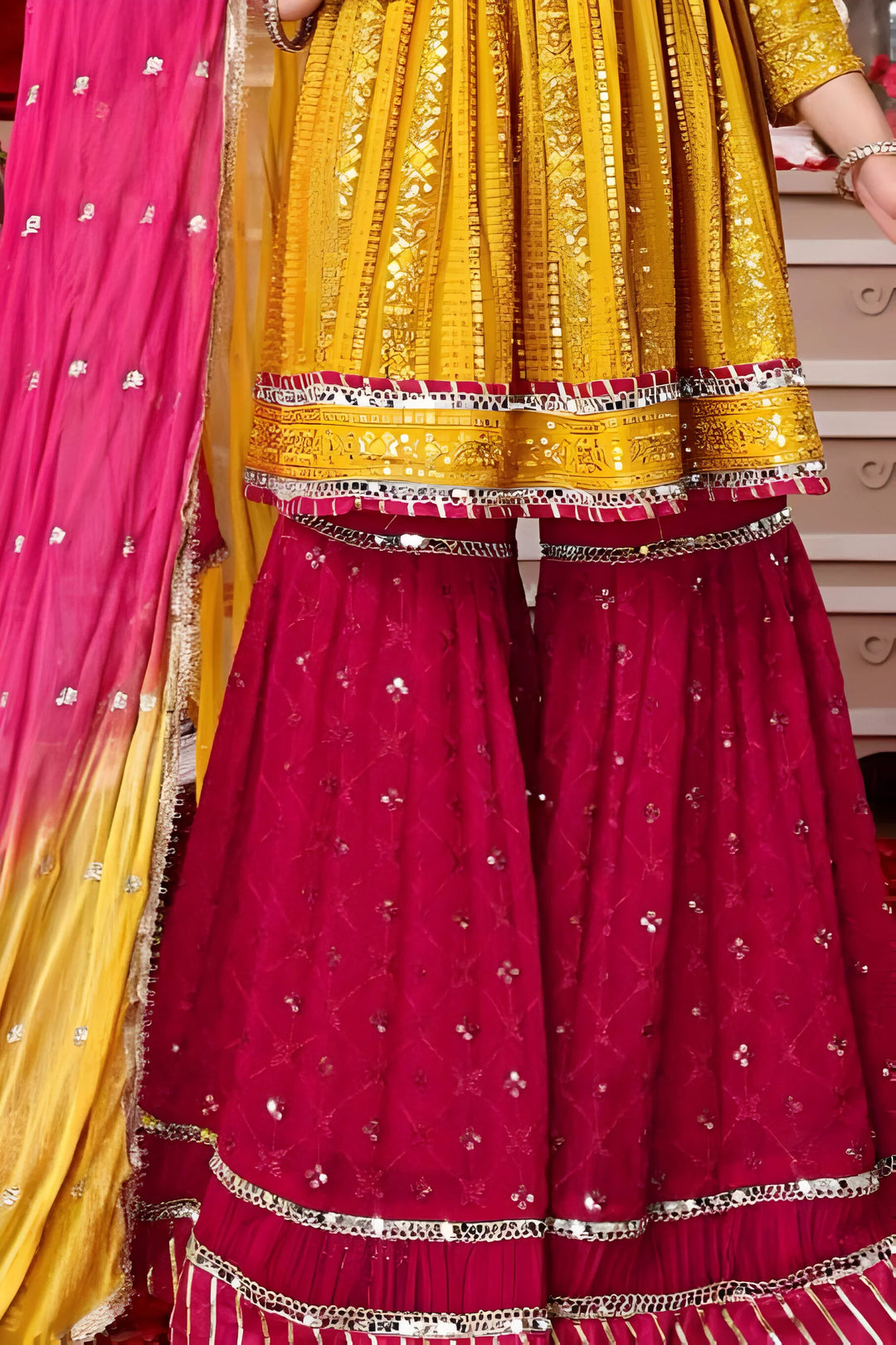 Stylish yellow georgette Garara set with detailed multicolor embroidery.