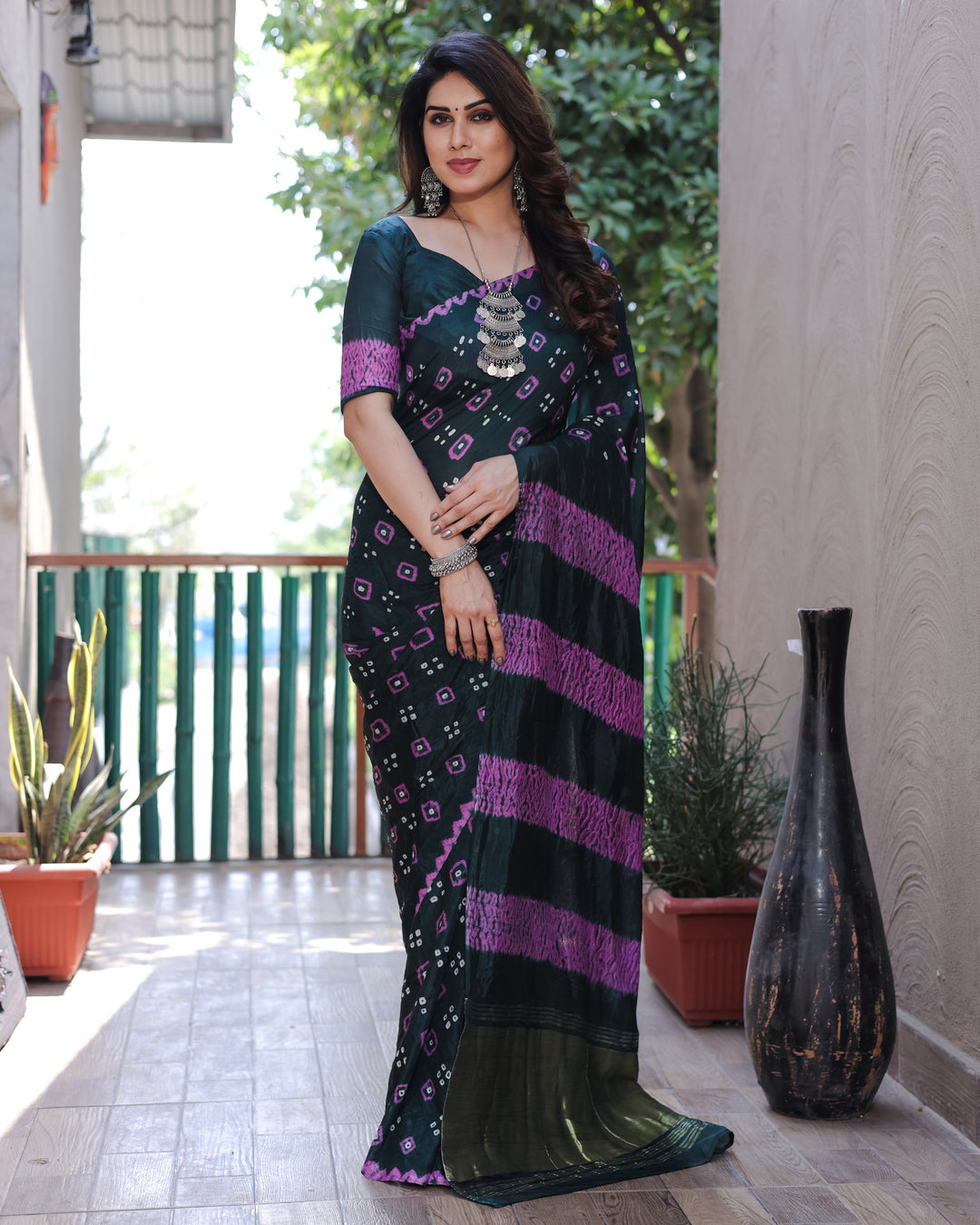 Stunning dark green Bandhej silk saree with intricate Zari work and Sibory motifs, perfect for weddings and festivals.