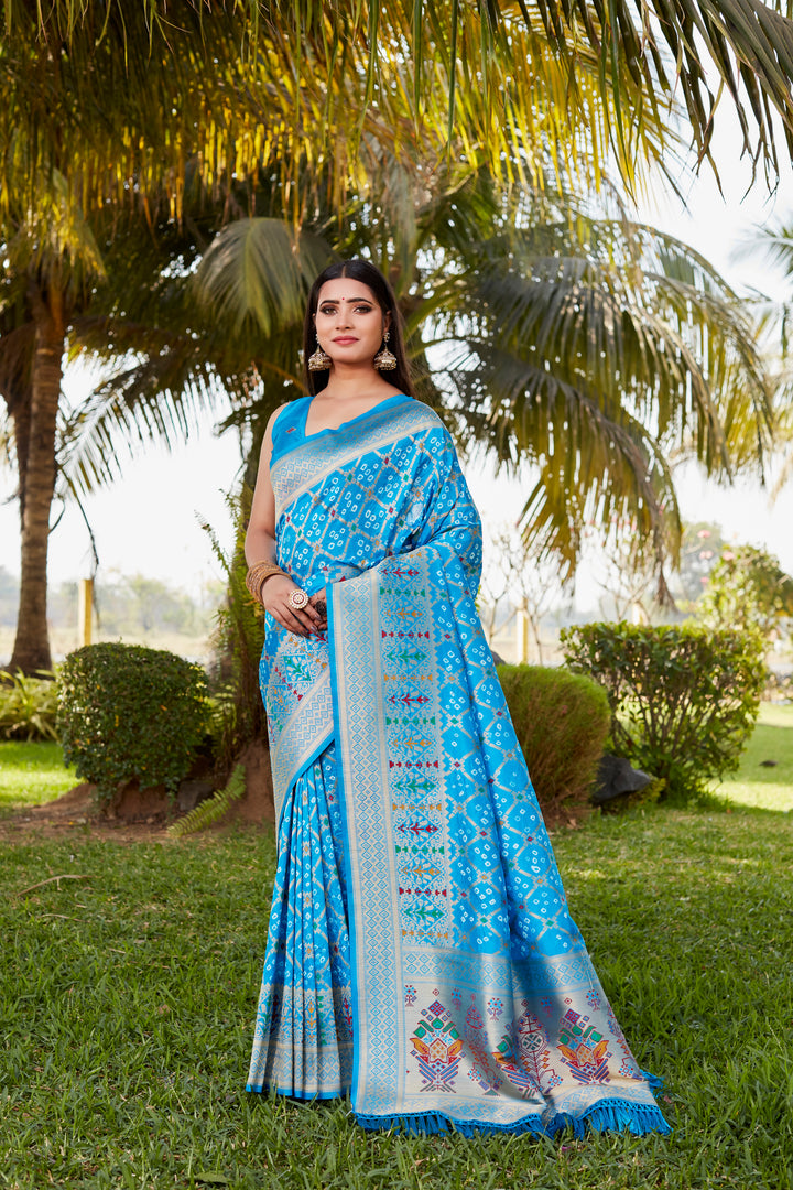 Stunning red Gharchola Bandhej silk saree with zari and meenakari detailing, ideal for cultural celebrations and special occasions.