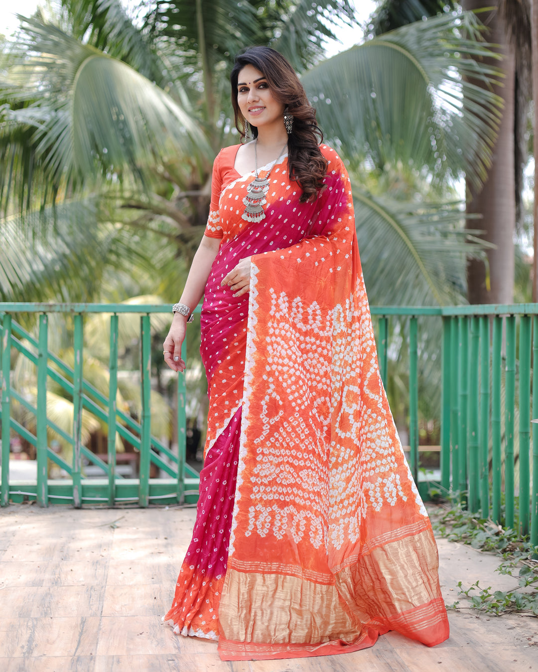 Stunning Ruby-Red Bandhej Silk Drapes featuring Zari Tissue Pallu and blouse piece for luxury events.