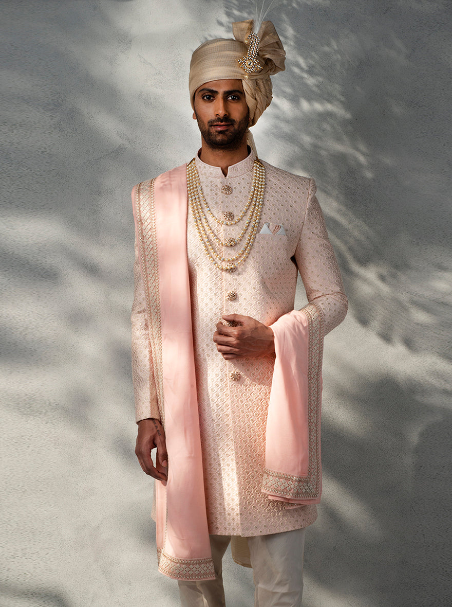 Men's pink Indo Western dress featuring silk blend fabric, embroidered buttons, and trendy loafers.